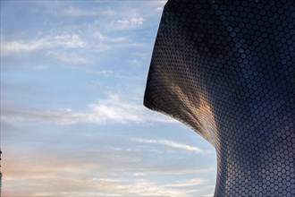 soumaya museum in CDMX, mexico. sunset reflection of the sunset on the building, aluminum panels or alucobon