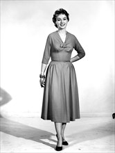 Woman wearing summer dress. Circa 1955