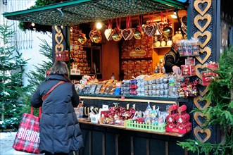 Traditional seasonal stall at the  main Christmas market with snow on the ground in the centre of Salzburg, Austria