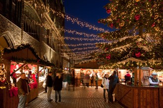 Illuminated booths and stands at Christmas market in the Hanseatic City of Lübeck, Germany