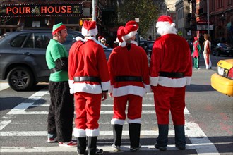 young people dressed as Santa Claus, gather in Manhattan for SantaCon 2011, New York City, NYC, USA