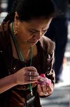 Oaxacan woman carving radish figure for Noche de Rabanos, Oaxaca, Mexico.