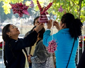 Four women prepare a carved radish angel at the Noche de Rabanos competition, Oaxaca, Mexico.