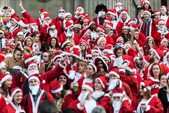 London, UK. 14th December, 2013.  Hundreds of Santas gather on the steps of St Pauls Cathedral before they march off to meet up with groups of other Santas to celebrate the annual Santacon.  Photograp...