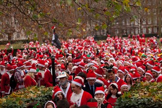 London, UK. 14th of December 2013 Annual Santa Con gathering hits Central London. Every year in December thousands of people dress up as Santa for the annual get together of Santa Con, they walk from ...