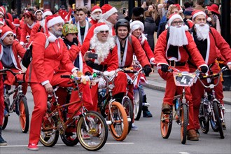 BMX bikers dressed as Santa Clause ride down Oxford Street