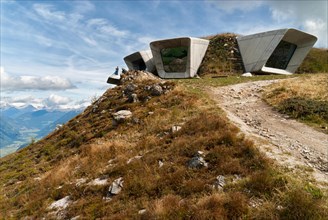 Bruneck, Italy - September 7, 2017: Backside of Messner Mountain Museum Corones (Mount Kronplatz, Dolomites) desgined by Zaha Hadid and paraglider