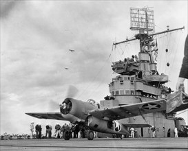 A Grumman F4F-4 Wildcat fighter taking off from USS Ranger (CV-4) to attack targets ashore during the invasion of Morocco, circa 8 November 1942. Note: Army observation planes in the left middle dista...