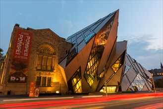 Night wide-angle view of the North facade of the Royal Ontario Museum in Toronto, Canada, with Daniel Libeskinds the Cube.