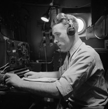 War Volunteers in Malacca and Indonesia Description: The first telegraphist in the Skymaster 313 with Van de Poll aboard at Bangkok Date: February 1946 Location: Thailand Keywords: telegraphs, aircraf...