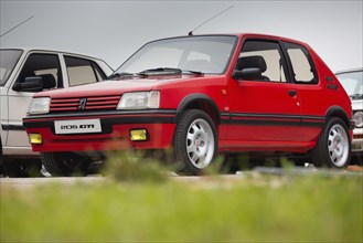 Cobreces, Spain - August 14, 2021: Car show in Cobreces. Original red Peugeot 205 GTI. The Peugeot 205 is a car produced by the French manufacturer Pe