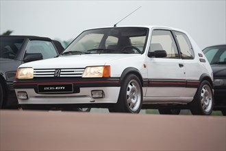Cobreces, Spain - August 14, 2021: Car show in Cobreces. Original white Peugeot 205 GTI. The Peugeot 205 is a car produced by the French manufacturer