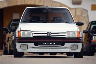 Reocin, Cantabria, Spain - October 2, 2021:  Car show in Reocin. Original white Peugeot 205 GTI. The Peugeot 205 is a car produced by the French manuf