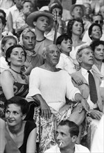 Famous artist Pablo Picasso (1881-1973), with his last lover, Jacqueline Roque, and Jean Cocteau (1889-1963), renowned artist and writer, at a bullfight in Spain.