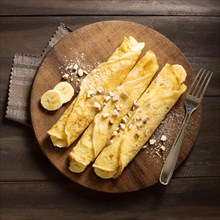 Delicious winter crepe dessert with bananas. High quality beautiful photo concept
