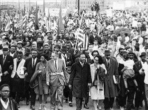 Martin Luther King, Jr. leads nonviolent demonstrators into Montgomery, Alabama, toward the steps of the Alabama State Capitol Building on March 25, 1965, the final day of the Selma to Montgomery Marc...