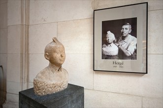 Stone bust of Tintin (by the belgian sculptor Nat Neujean in 1952) with the picture of Hergé (creator of Tintin), Comics Art Museum, Brussels, Belgium
