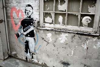 Banksy stencil of boy painting heart, Islington, London