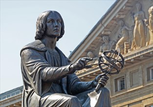 the Polish astronomer Nicolaus Copernicus, holds a compass and armillary sphere,  Warsaw, Poland.
