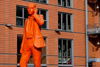 The man with a phone, orange sculpture by Xavier Veilhan, Lyon International city, Lyon, France