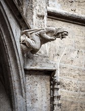Gargoyle like medieval witch on wall of Rathaus or New Town Hall on Marienplatz Square, Munich, Bavaria, Germany. This building is landmark of Munich.
