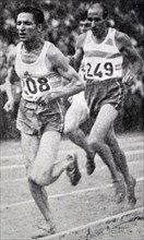 Black and white photograph of French runner Alain Mimoun (1921-2013) taking the lead against fellow French runner Raphael Pujazon (1918-2000).