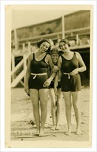 Original 1920's or 1930's era postcard of 3 happy attractive young ladies posing for photo in their woollen swimming costume at a famous British seaside resort called Margate, Kent, England, U.K.