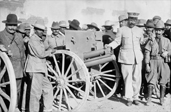 Pancho Villa with gun and soldiers, circa 1915