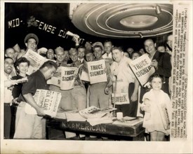Jul. 27, 1953 - News For All: There's just one reaction: happiness from eager buyers of extra editions of newspapers in Times square her last night after the signing of the armistice agreement in Kore...