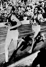 Finland 1952 Olympics, Emil Zatopek (CZE), from left, followed by Alain Mimoun (FRA), competes in 10 km race at Helsinki.