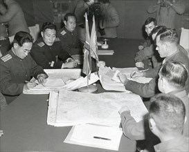 Panmunjom, Korea - Col. James C. Murray, Jr., USMC (rt) and Col Chang Chun San, of the North Korean Communist Army (left) initial maps showing the North and South boundaries of the Demarcation Zone, d...