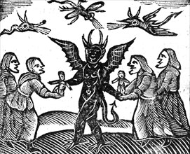 WITCHCRAFT A group of witches offering wax effigies to the Devil in a 17th century woodcut