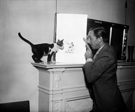Walt Disney with Mickey Mouse drawing and cat ca. 1931