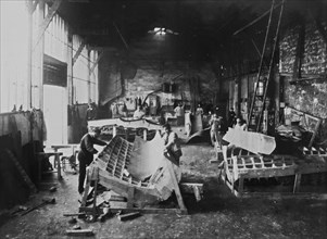 Men in a workshop shaping sheets of copper for the construction of the Statue of Liberty.