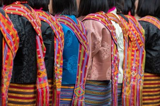 Bhutan, Punakha Dzong. Punakha Drubchen Festival, female dancers in traditional colorful attire.