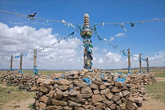 Ovoo / oboo / obo, Mongolian sacred stone heaps with blue khadags, ceremonial silk scarves used, as altars or shrines in the Gobi desert, Mongolia