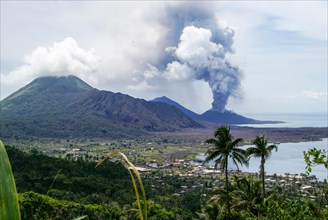 Looking across the town of Rabaul; Papua New Guinea toward the active Tavurvur volcano.
