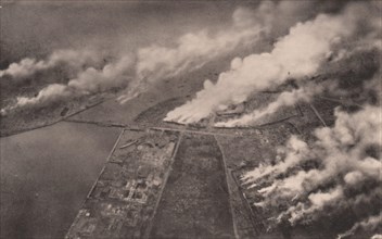 Japan Earthquake 1923: Tokyo ablaze : a horrible scene on the banks of the sumida river, as snapshot from on board a military aeroplane