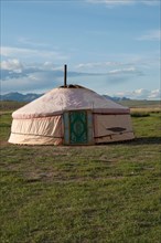 Mongolian traditional house named ger or yurt, in a beautiful landscape. Blue sky. Rural area near Kharakhorum, Mongolia. These houses are now used to