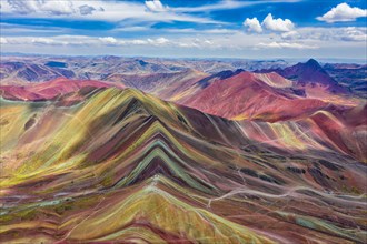 Aerial view of the entire Rainbow Mountains in Peru with Vinicunca in the center and the Red Valley in the background.