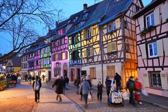 Traditional old half-timbered houses in the historic city of Colmar. Decorated and lighted during the Christmas season. Colmar, France - December 2022