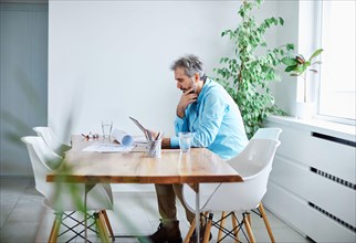 senior businessman tablet desk office work business computer grey hair mature casual reading work