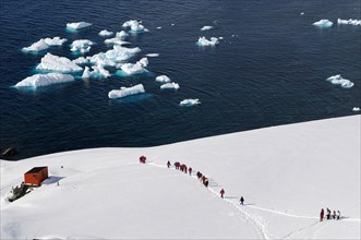 Tourists at Antarctic base Almirante Brown in Paradise Bay, Antarctic Peninsula, Antarctica