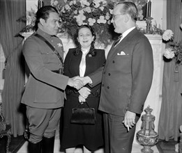 Col. Fulgencio Batista is shown with his seldom photographed wife, and the ambassador from Cuba Dr. Pedro Fraga