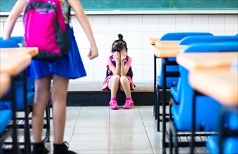 little girl bullying in school classroom