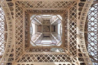Eiffel tower structure under view in Paris, sunny day