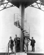 Gustave Eiffel and four other people at the summit of the Eiffel Tower at the time of the Paris Exposition Universelle in 1889, for which the tower was built.