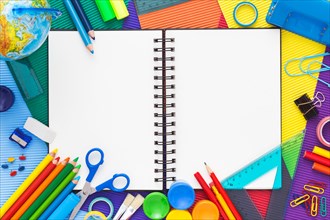Back to school. Colorful composition of school supplies and blank notebook. Flat lay.