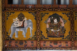 Buddhist religious paintings, including a Dharma Wheel on the back of an elephant on the Buddhist temple in Punakha, Bhutan