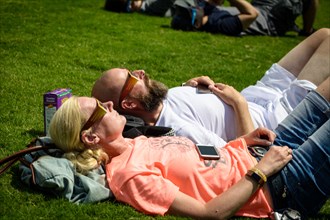 Nashville, Tennessee, USA. 21th August, 2017. A couple rests on the ground looking up at the sky in Centennial Park in Nashville, Tennessee, USA watching the solar eclipse that spanned a 70-mile wide ...